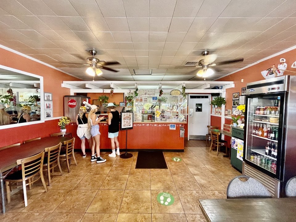Casual dining room with counter service and tables.