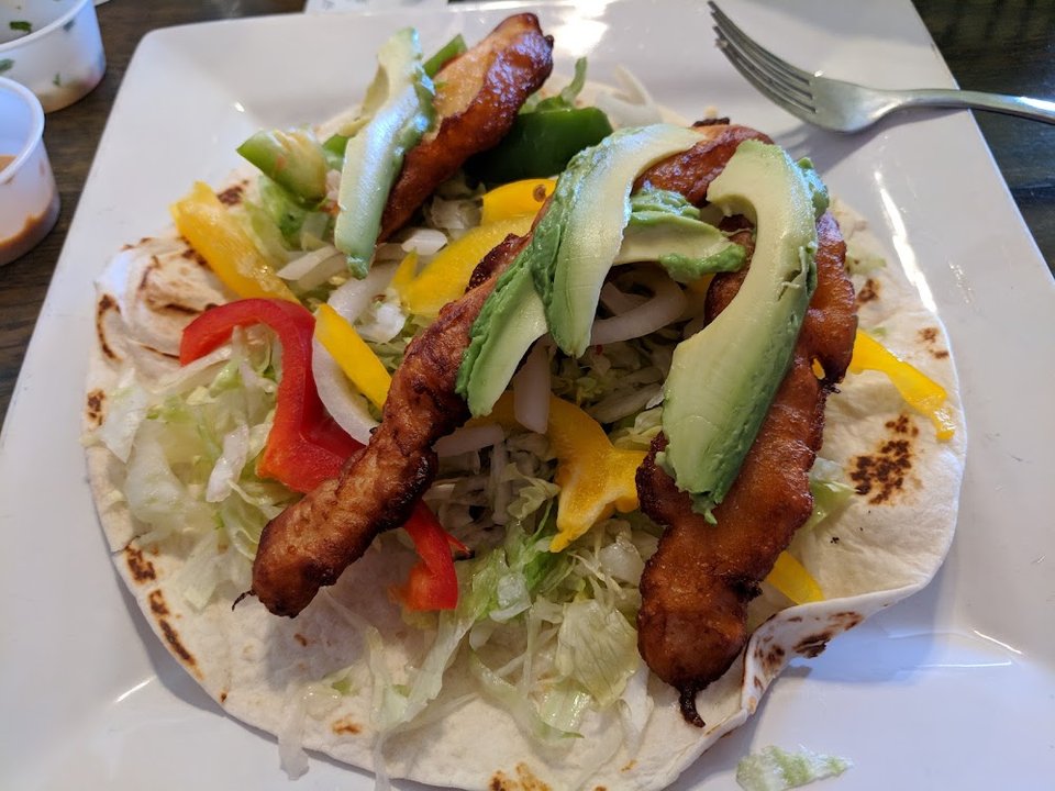 Printed menu with tacos, plates, and breakfast dishes.