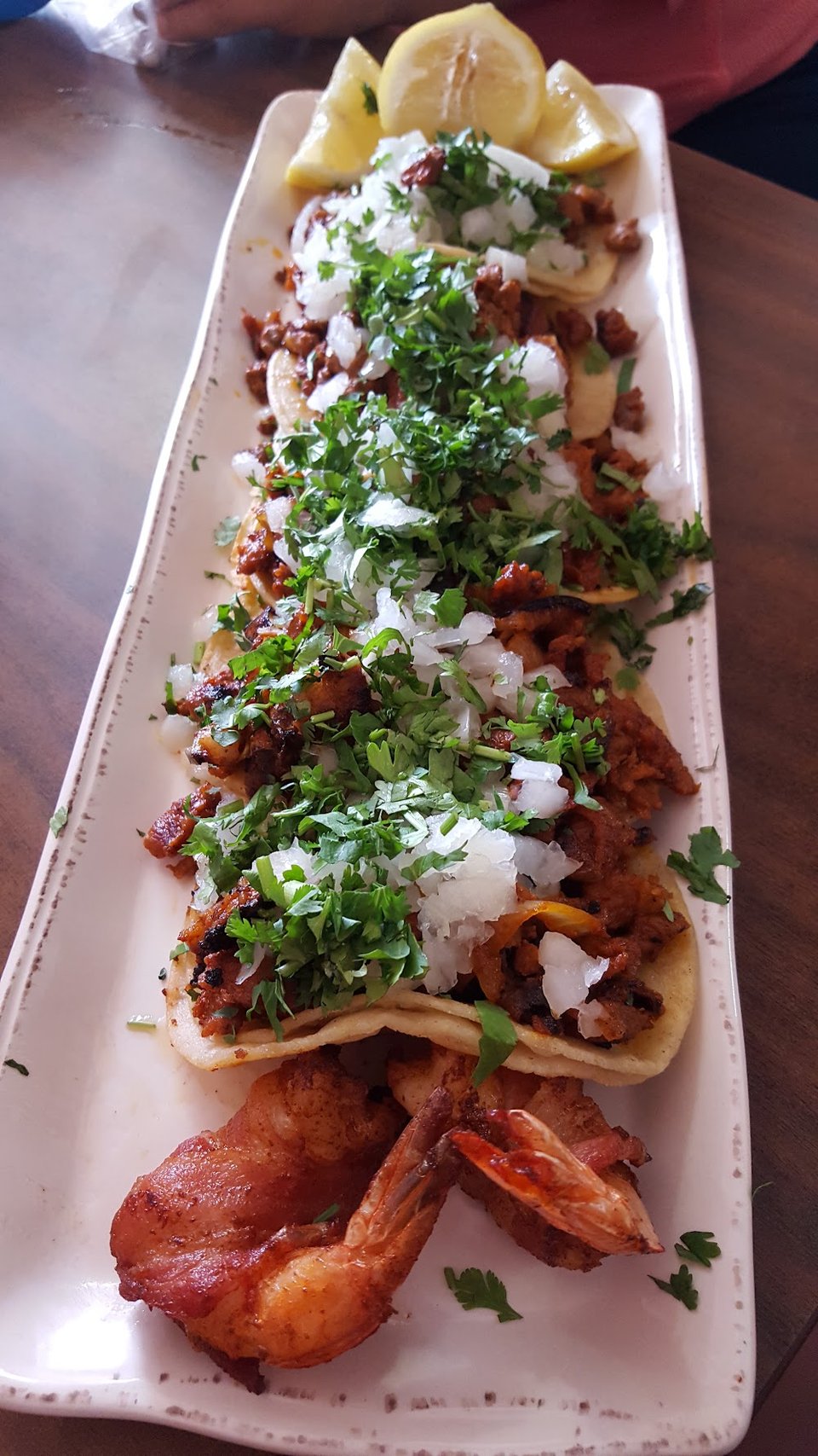 Printed menu with tacos, plates, and breakfast dishes.